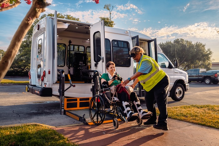 LYNX ACCESS vehicle lowering a passenger using a wheelchair lift