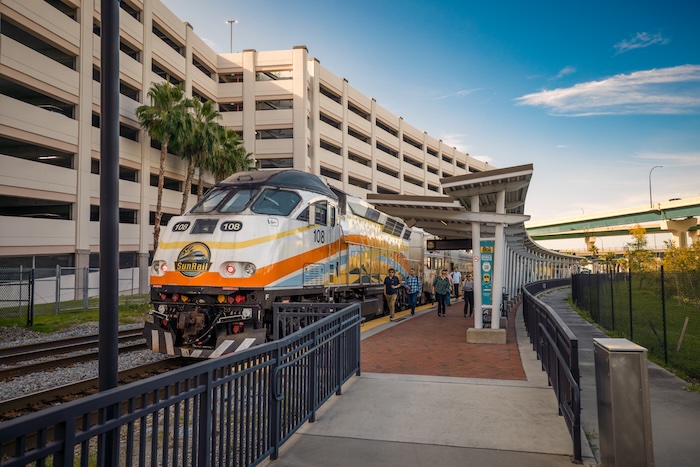 SunRail commuter train stopped at a station platform