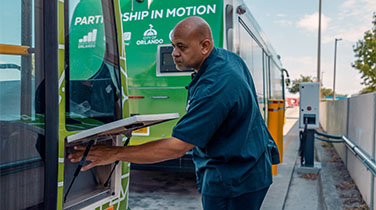Employee working on an electric bus