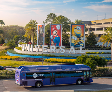 blue LYNX bus driving past a big universal sign